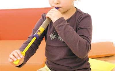 Child playing the slide flute